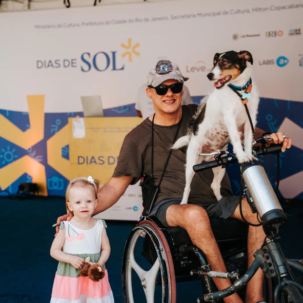 Menina e cadeirante com seu cachorro no palco do Festival Dias de Sol